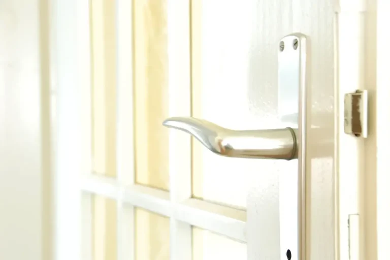 How to change a uPVC door lock in Consett – white door with a lever handle on a long backplate, Locksmith Consett guide to barrel, handle and multipoint replacement